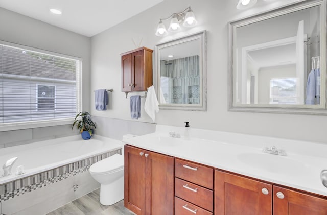 145 Woodbrook Way, Moncks Corner, SC 29461 - bathroom featuring toilet, a garden tub, double vanity, and wood finished floors