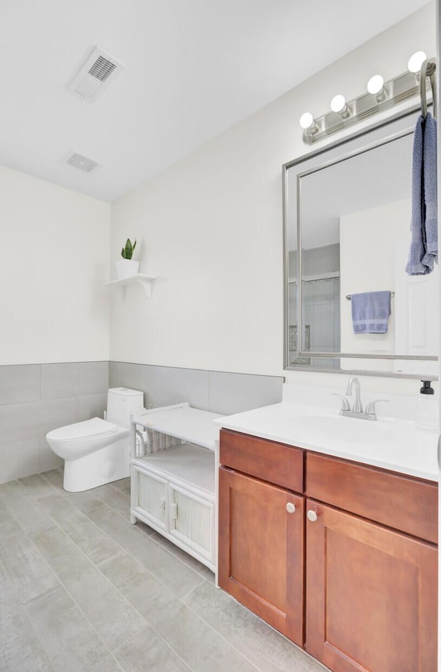 145 Woodbrook Way, Moncks Corner, SC 29461 - bathroom with vanity, toilet, tile patterned floors, and tile walls