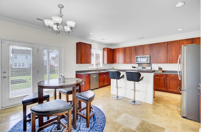 145 Woodbrook Way, Moncks Corner, SC 29461 - kitchen featuring stainless steel appliances, crown molding, a chandelier, reddish brown cabinets, and a center island