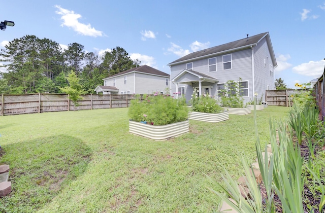 145 Woodbrook Way, Moncks Corner, SC 29461 - rear view of property featuring a garden