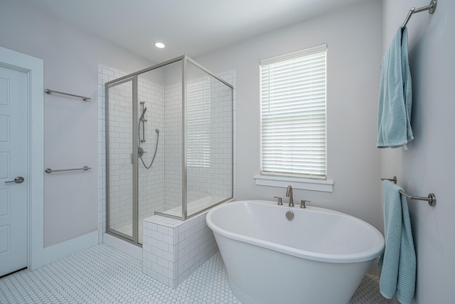 full bathroom with recessed lighting, tile patterned flooring, a stall shower, and a soaking tub