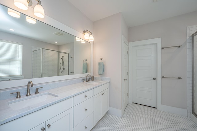 full bath featuring a sink, a stall shower, and double vanity