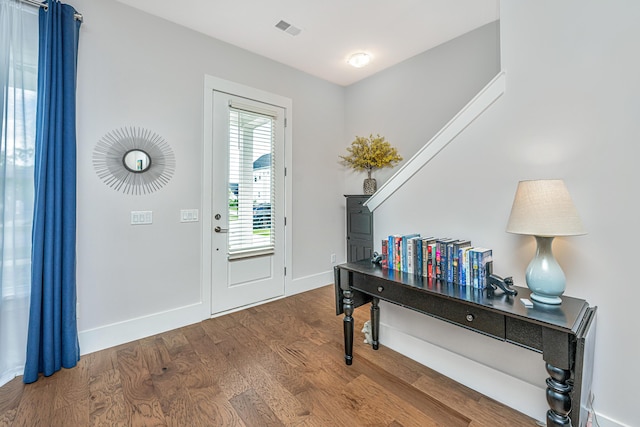 foyer with visible vents, baseboards, and wood finished floors