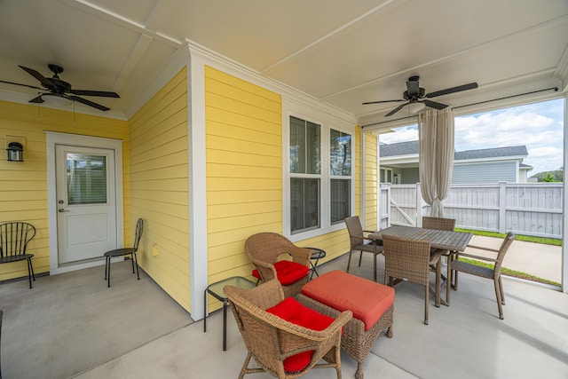 view of patio with ceiling fan, fence, and outdoor dining area