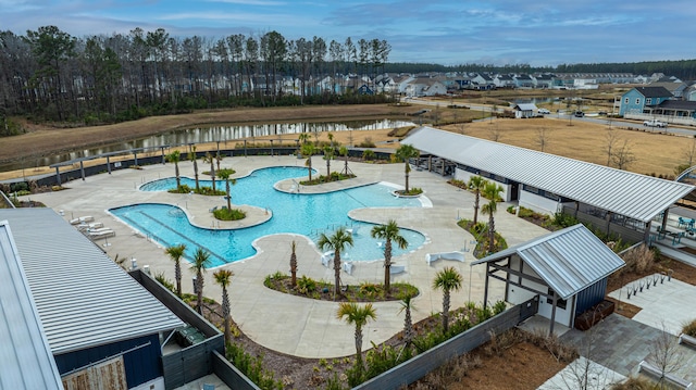 community pool with fence and a patio area