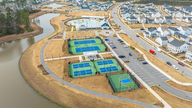 drone / aerial view featuring a residential view and a water view