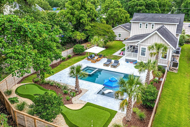 619 Thomas Glenn Ct, Charleston, SC 29412 - back of house with an area to practice putting, board and batten siding, roof with shingles, outdoor lounge area, and a fenced backyard