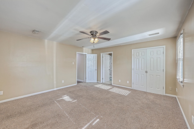 unfurnished bedroom with carpet flooring and ceiling fan