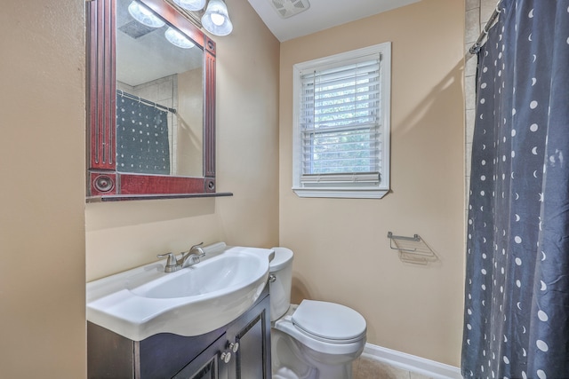 bathroom featuring vanity, toilet, and curtained shower