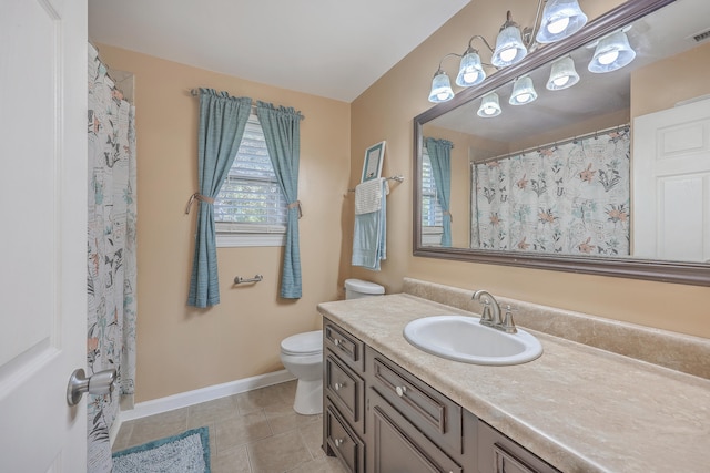 bathroom featuring tile patterned flooring, vanity, and toilet