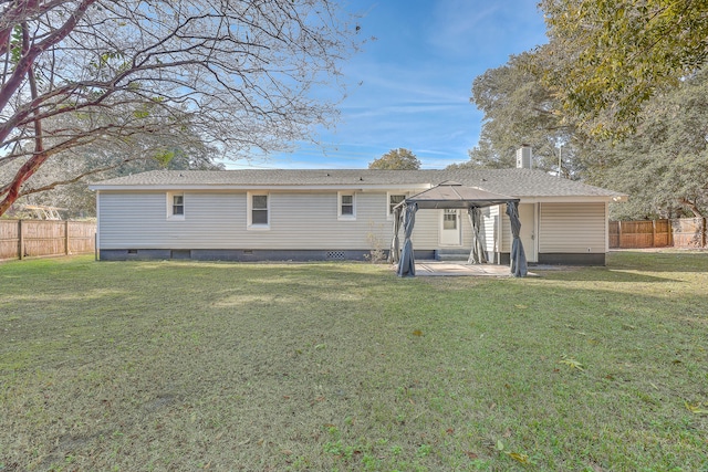 rear view of house featuring a gazebo, a patio area, and a yard