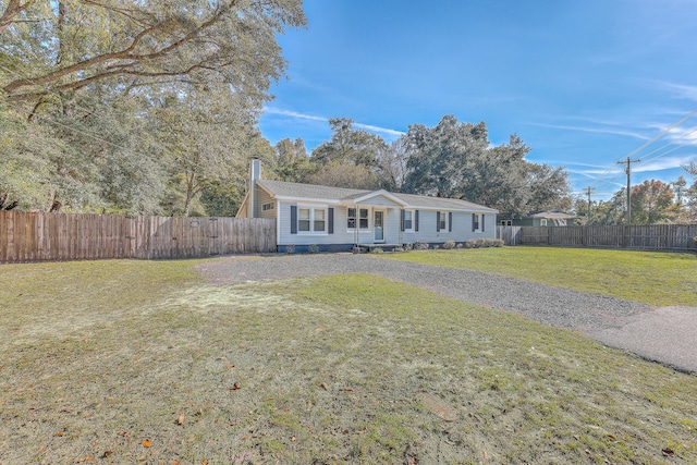 ranch-style house with a front lawn