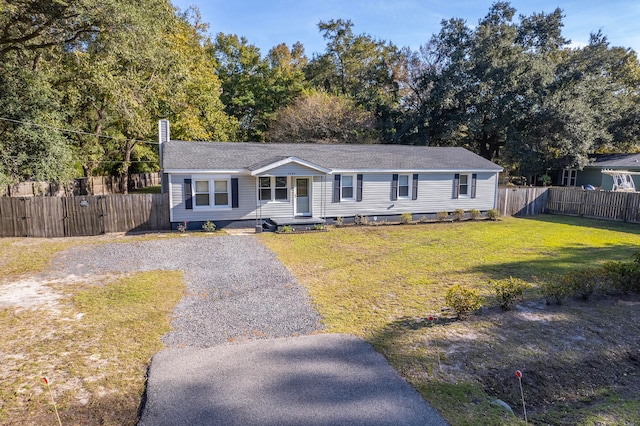 ranch-style home with a front lawn