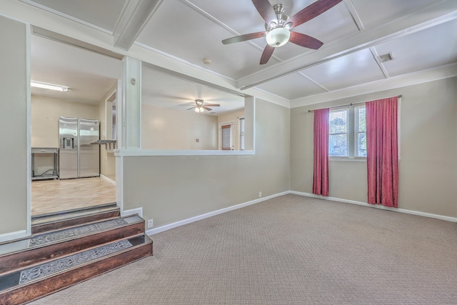 carpeted empty room with ceiling fan and ornamental molding