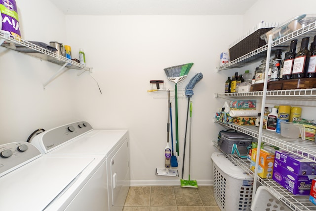 laundry area with washer and dryer and light tile patterned floors