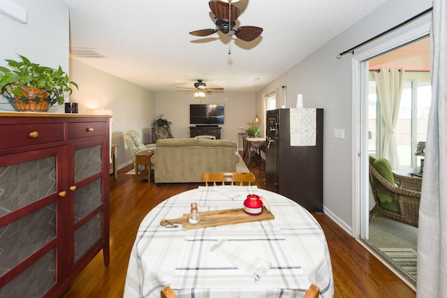 dining room with ceiling fan and dark hardwood / wood-style floors