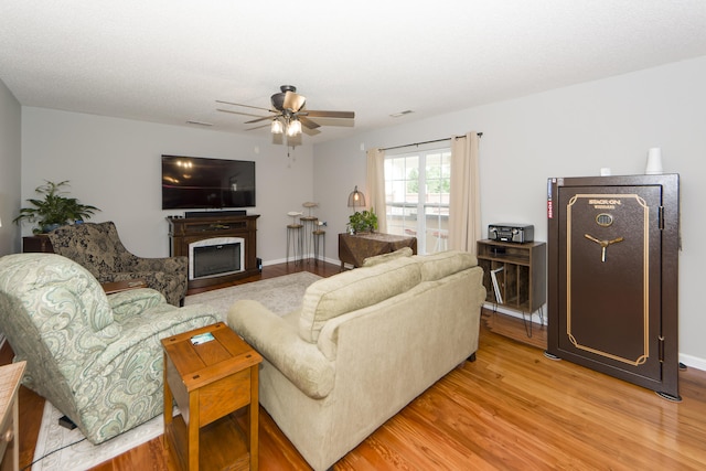 living room with ceiling fan and hardwood / wood-style flooring