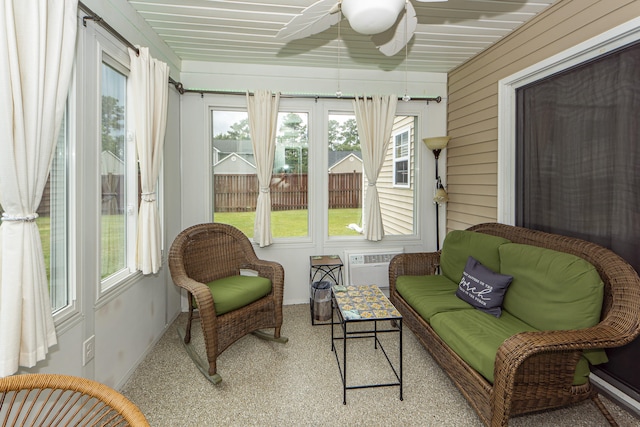 sunroom / solarium featuring a wall mounted AC and ceiling fan