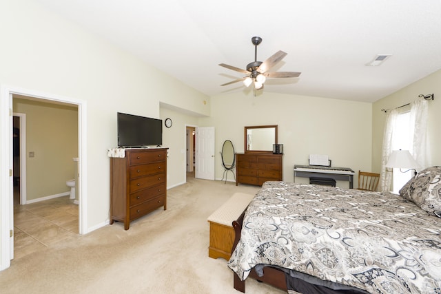 carpeted bedroom with ceiling fan, ensuite bathroom, and lofted ceiling