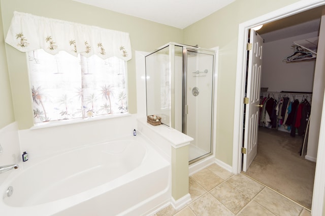 bathroom featuring tile patterned floors and independent shower and bath