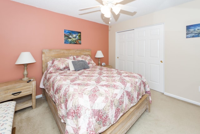 bedroom featuring a closet, ceiling fan, and light colored carpet