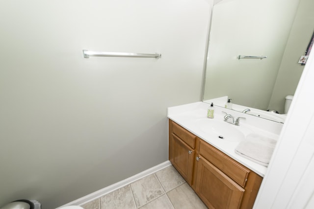 bathroom with tile patterned flooring, vanity, and toilet