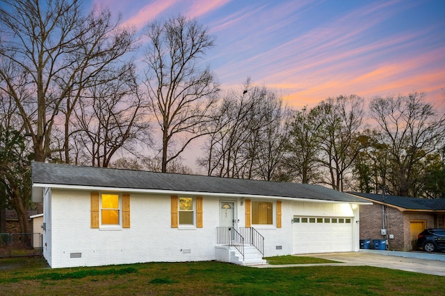 ranch-style house with a front yard, driveway, an attached garage, crawl space, and brick siding