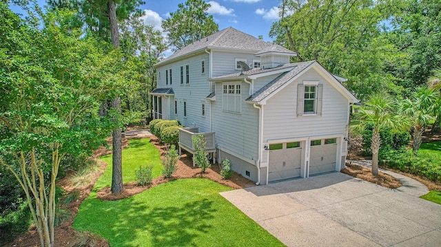 view of front of house with a garage and a front lawn