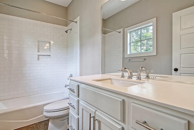 full bathroom featuring vanity, toilet, tiled shower / bath combo, and hardwood / wood-style floors