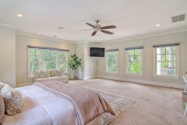 bedroom with ceiling fan, ornamental molding, and carpet floors