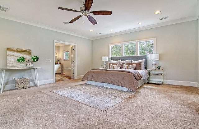 bedroom featuring ceiling fan, crown molding, ensuite bathroom, and light carpet