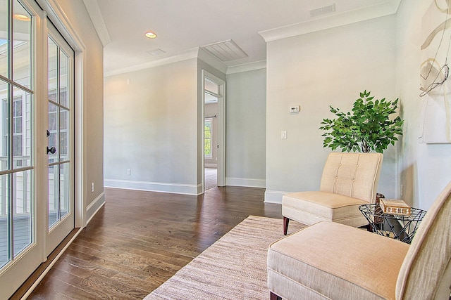 sitting room with ornamental molding and dark hardwood / wood-style flooring