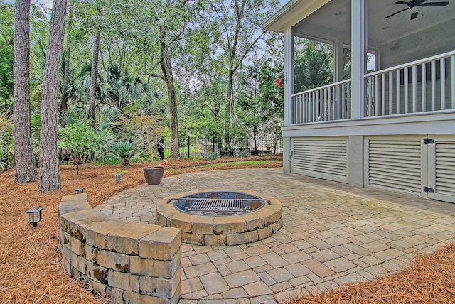 view of patio / terrace with an outdoor fire pit and ceiling fan