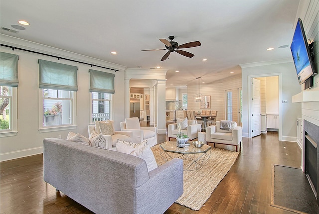 living room featuring crown molding, dark hardwood / wood-style flooring, and ceiling fan