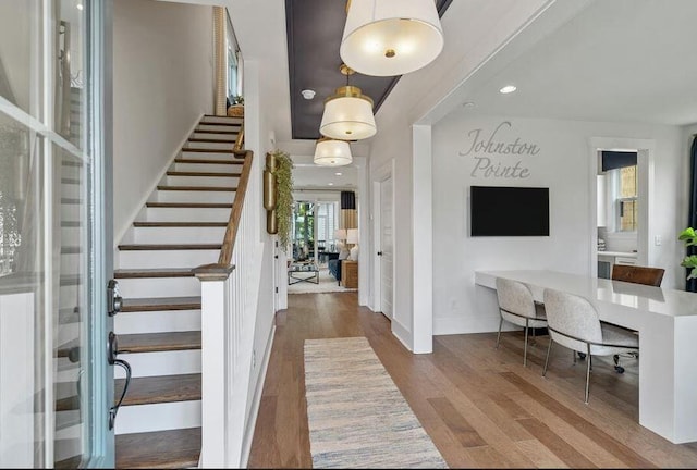 entryway featuring stairs, wood finished floors, baseboards, and recessed lighting