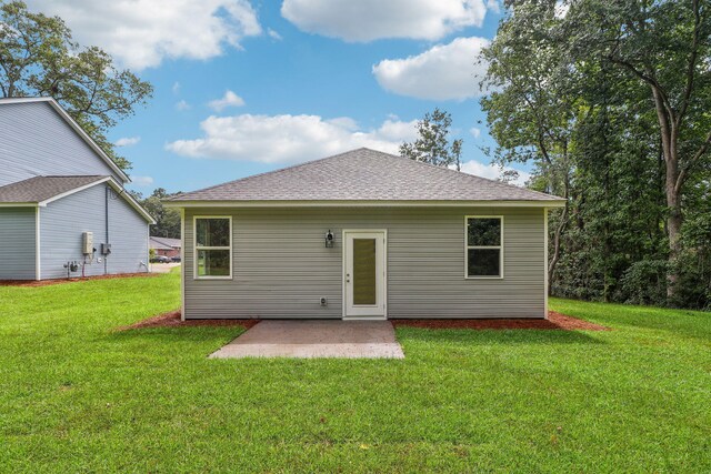 back of property with a patio and a lawn