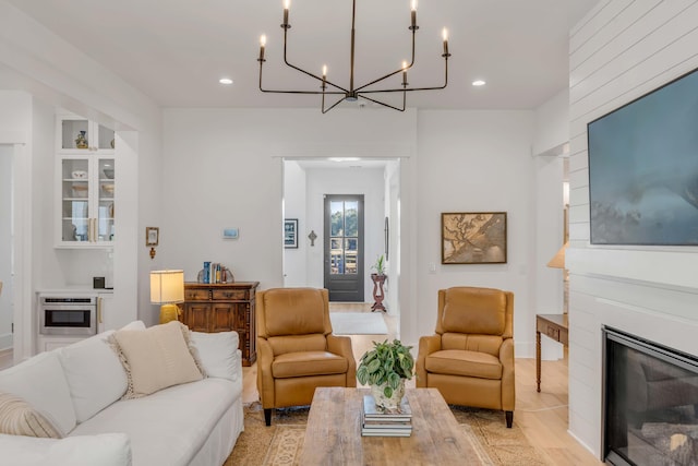 living room with a large fireplace and light hardwood / wood-style floors