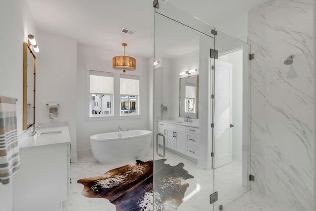 bathroom with vanity and shower with separate bathtub