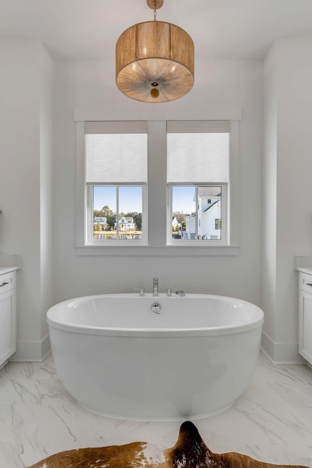 bathroom with vanity and a washtub