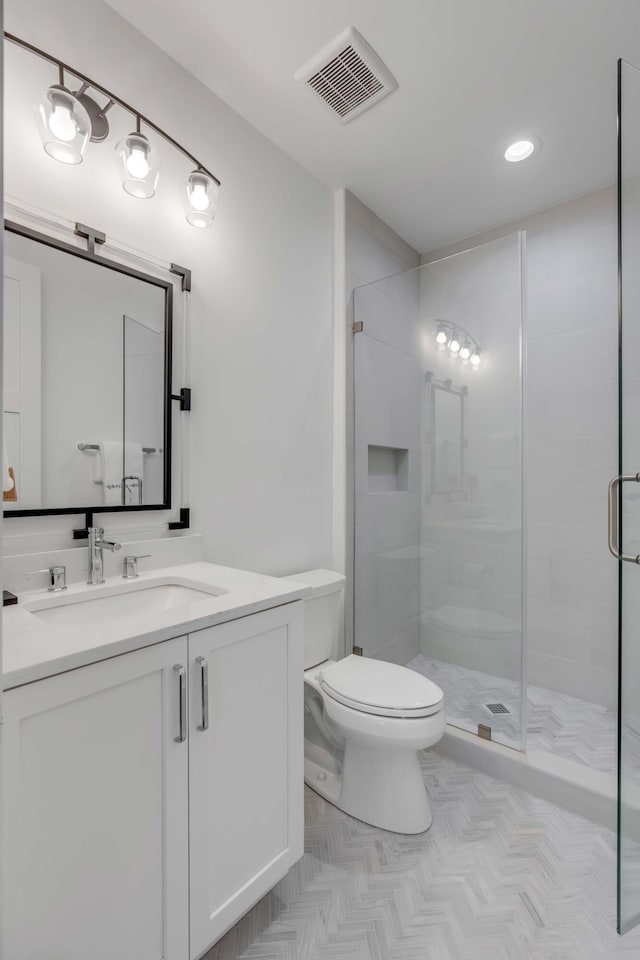 bathroom with vanity, toilet, and walk in shower