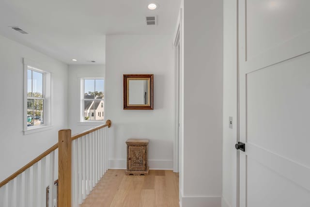 hallway with light hardwood / wood-style floors