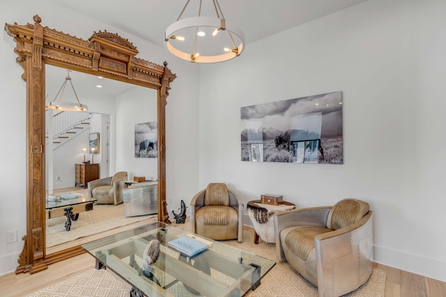 living room featuring a notable chandelier and light wood-type flooring