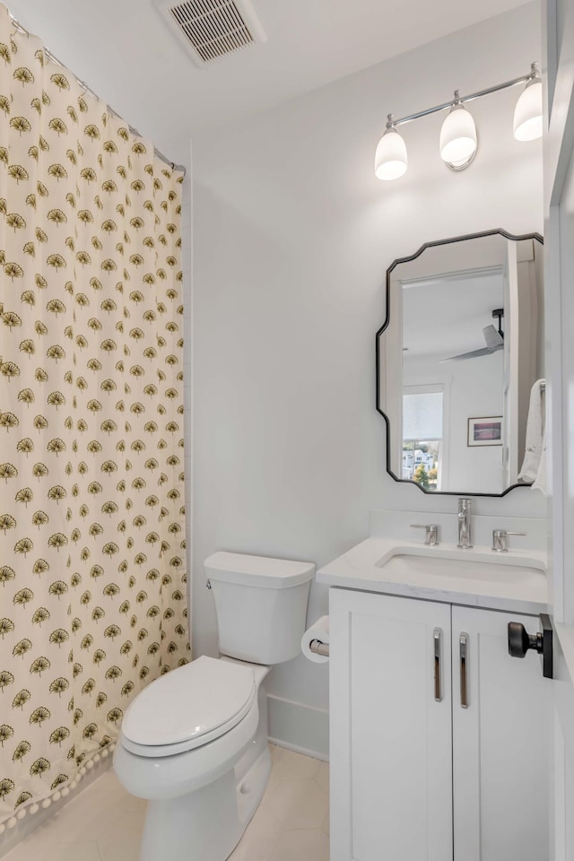 bathroom featuring toilet and vanity