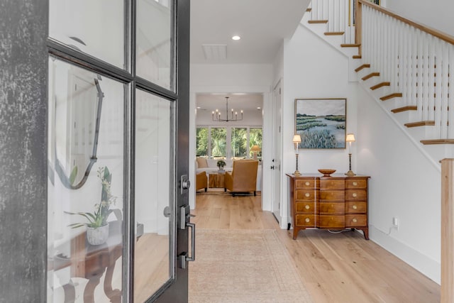 entrance foyer with a chandelier and light wood-type flooring