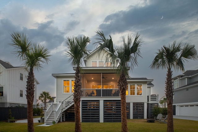 back of property featuring a yard and ceiling fan