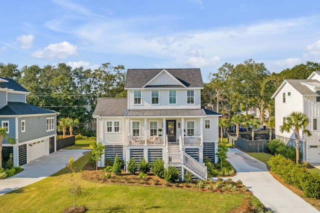 view of front facade featuring a front yard, a garage, and a porch