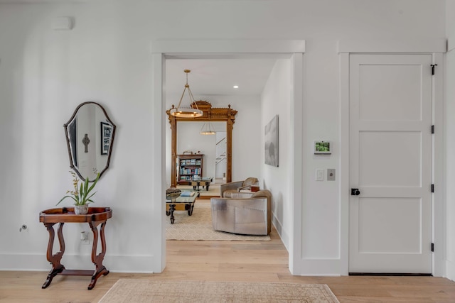 hallway with hardwood / wood-style flooring