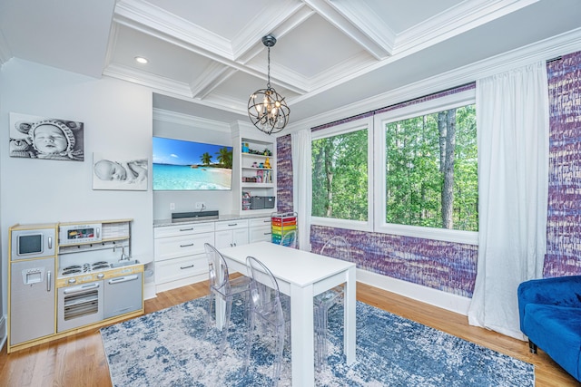 home office featuring a chandelier, crown molding, light wood-style flooring, coffered ceiling, and beam ceiling