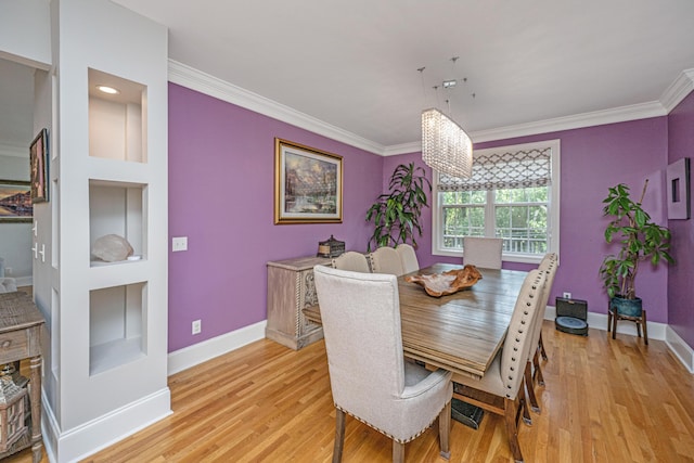 dining area featuring built in shelves, baseboards, crown molding, and light wood finished floors