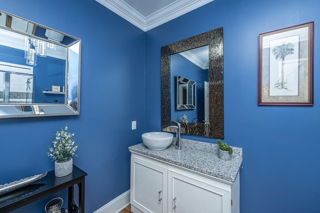 bathroom featuring crown molding, vanity, and baseboards